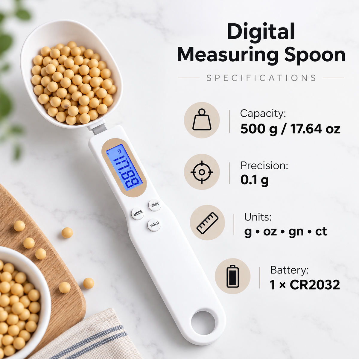 Specification graphic for a white digital measuring spoon showing 500 g capacity, 0.1 g precision, measurement units g, oz, gn and ct, and 1 x CR2032 battery