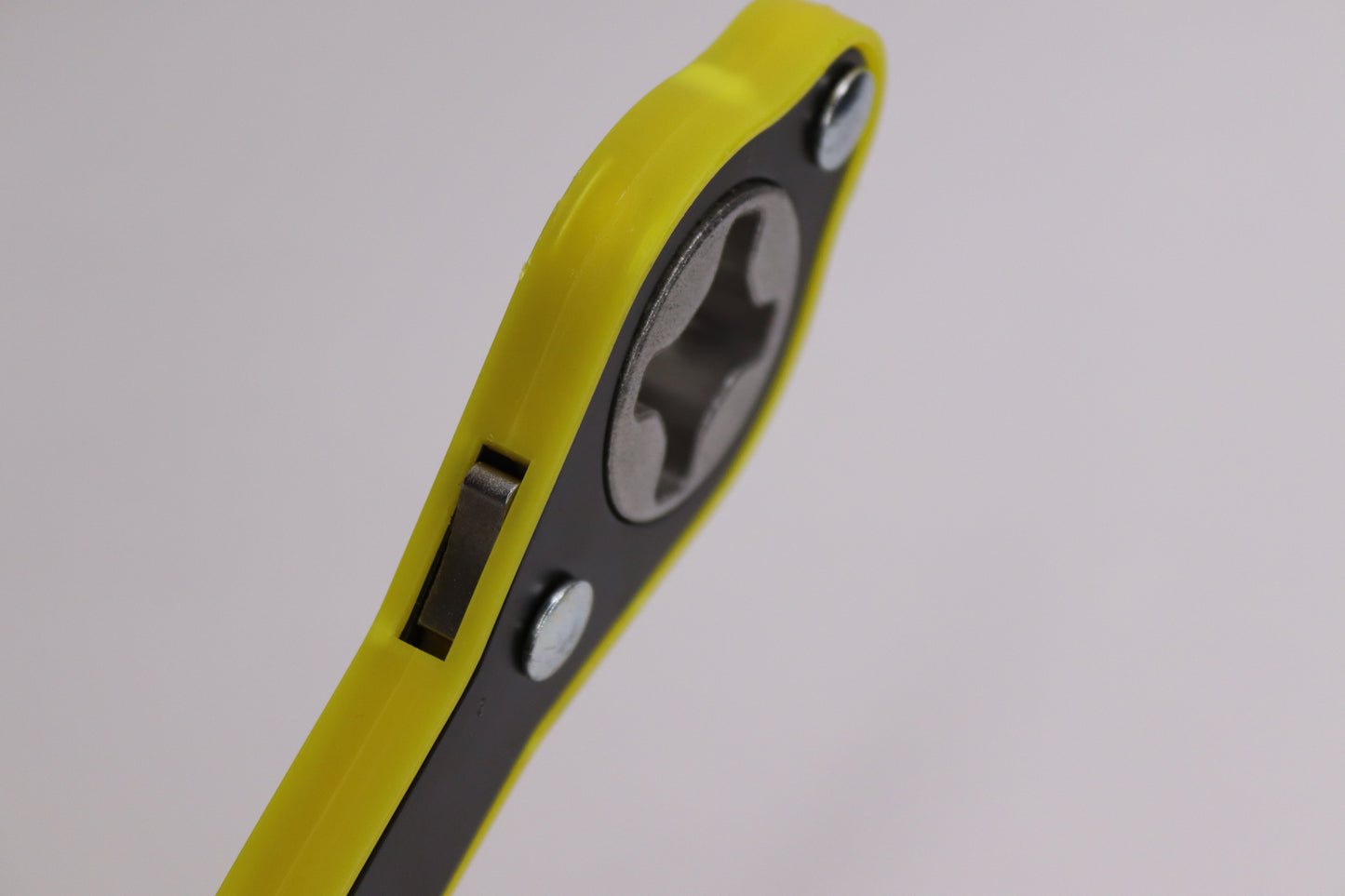 An angled view of a yellow and black car wrenching jack tool, featuring a durable metal head and ergonomic grip, ideal for loosening and tightening vehicle bolts with ease.