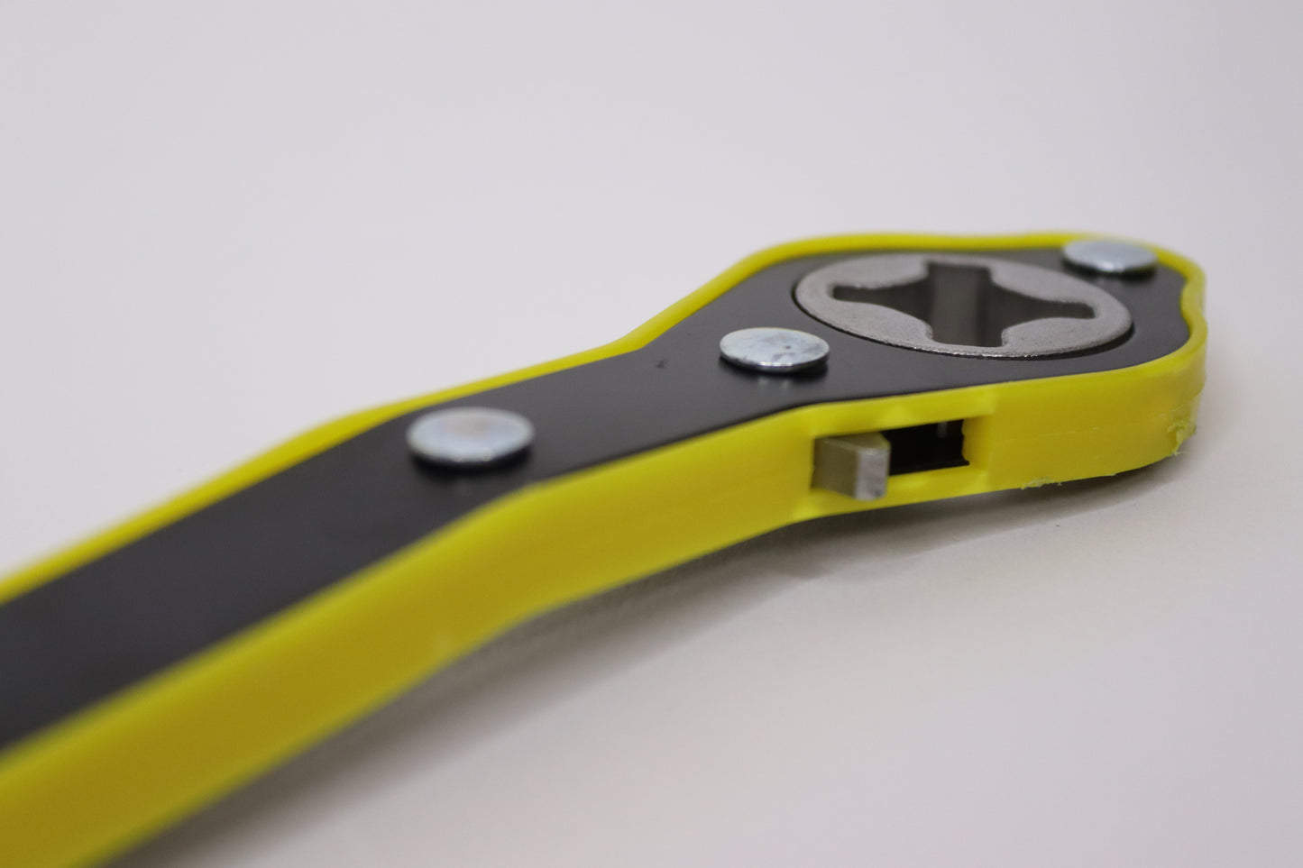 A close-up side view of a durable yellow and black car wrenching jack tool, featuring a sturdy metal grip and ergonomic design for efficient tightening and loosening of vehicle bolts.