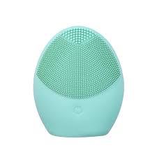 A compact green silicone facial cleansing brush with soft bristles and a power button, designed for deep pore cleansing, gentle exfoliation, and portable skincare use.