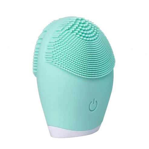 A green silicone facial cleansing brush with soft bristles and a power button, designed for gentle exfoliation, deep pore cleansing, and high-frequency vibration.