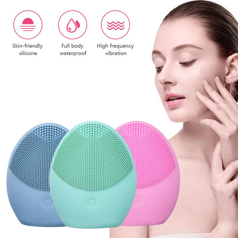 A trio of silicone facial cleansing brushes in blue, green, and pink, featuring skin-friendly material, full-body waterproof design, and high-frequency vibration, displayed beside a woman gently touching her smooth, radiant skin.