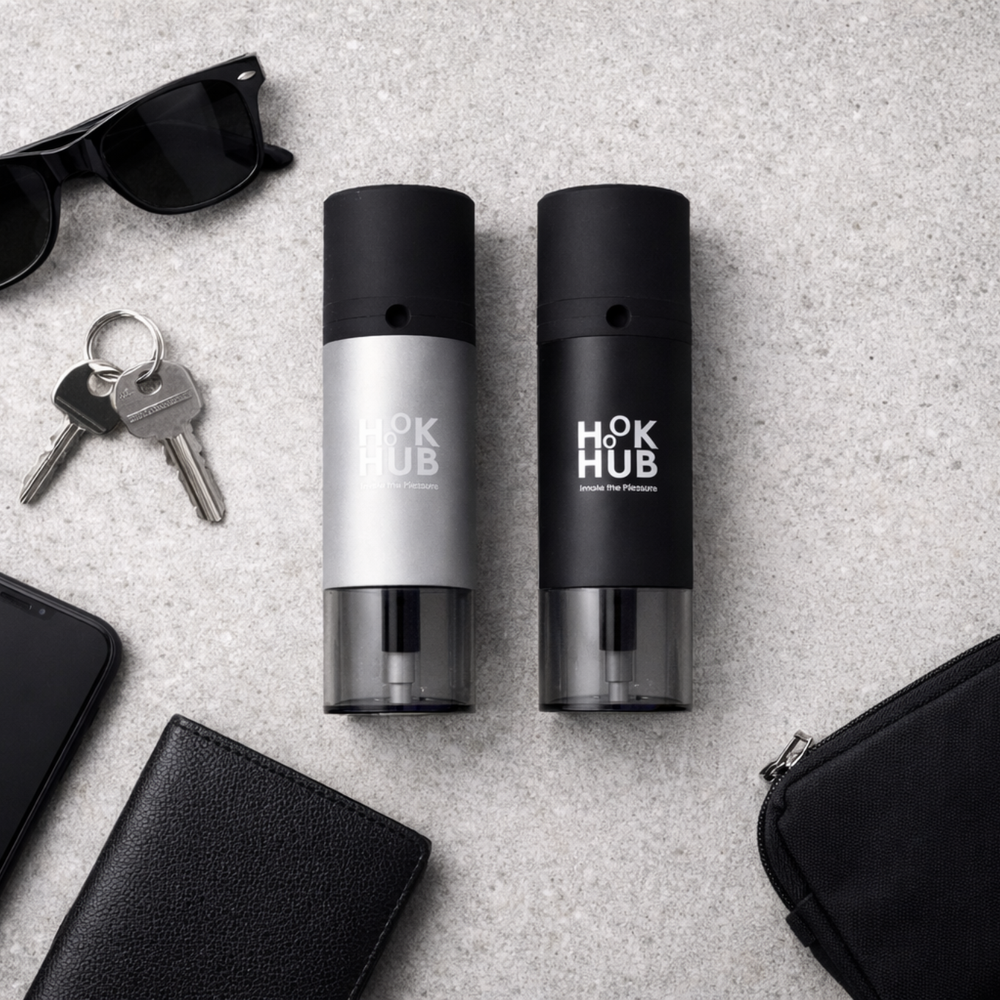 Hook Hub portable devices displayed in a flatlay with phone, sunglasses, keys, wallet and small pouch on concrete background.