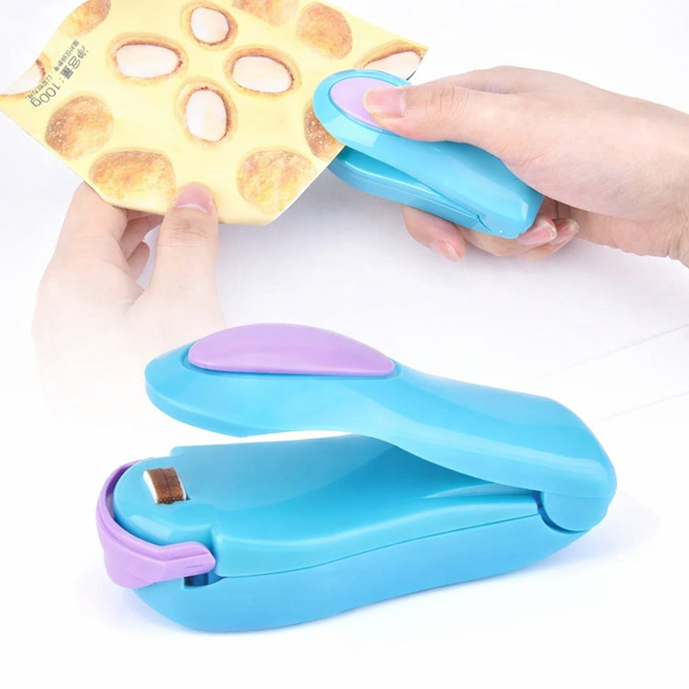 Using the blue mini bag sealer to reseal a snack bag; portable handheld heat sealer close-up.